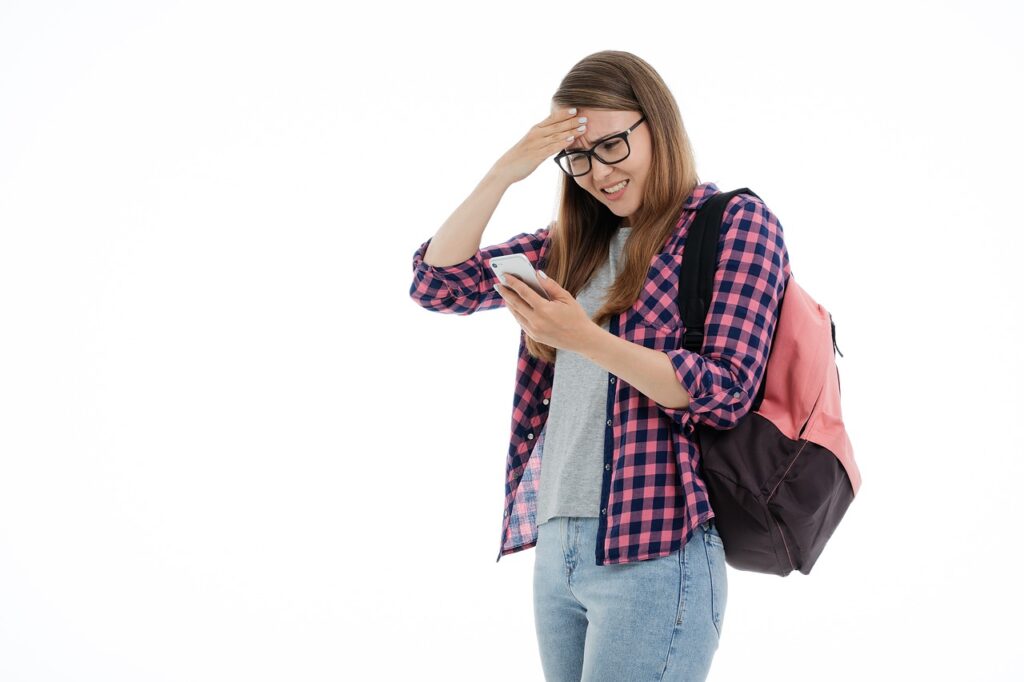 young girl student looking at smartphone