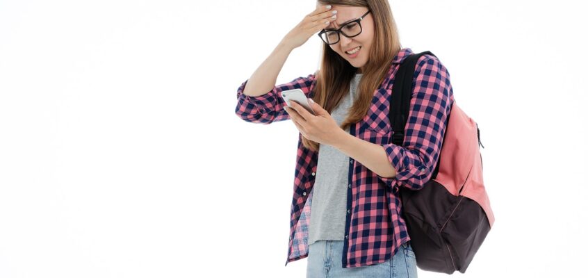 young girl student looking at smartphone