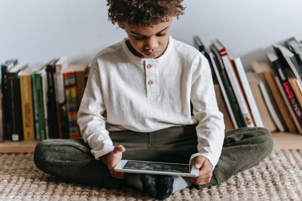 child playing video game on tablet