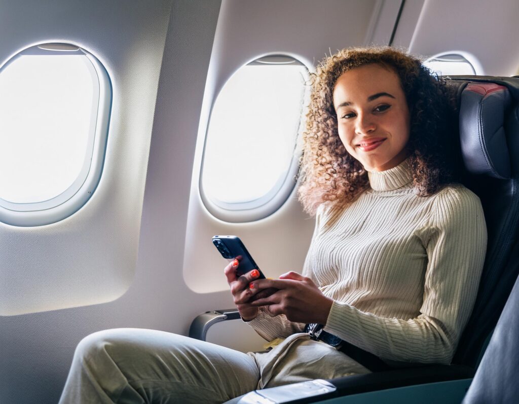 A young woman in an airplane seat