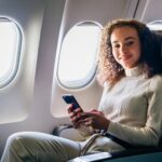 A young woman in an airplane seat