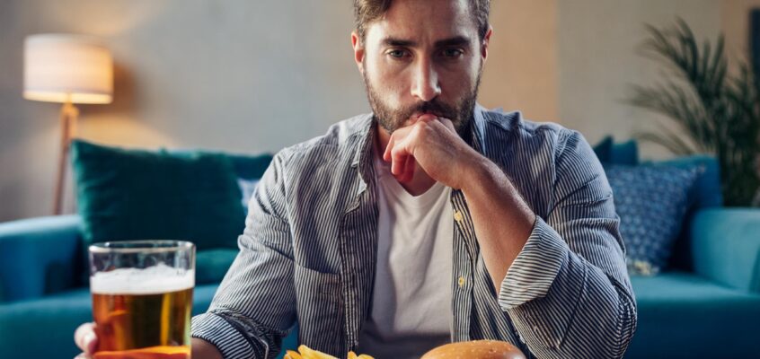 man eating unhealthy food